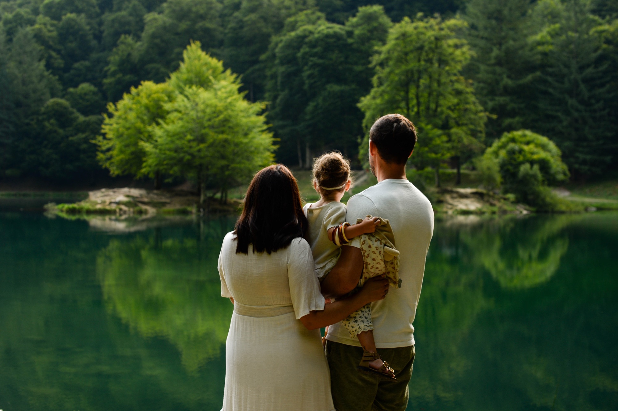 Famille de dos devant un lac vert ariégeois